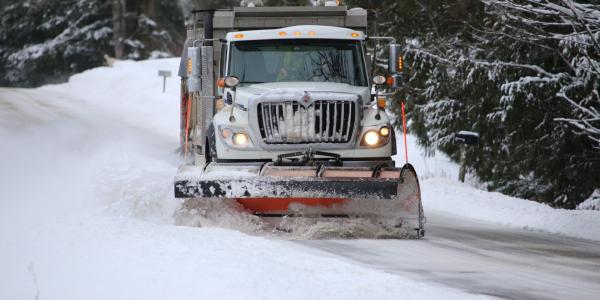 Snow plow on road