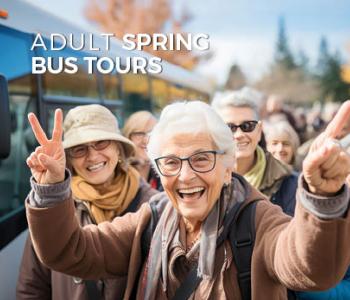 image of seniors smiling in front of a bus